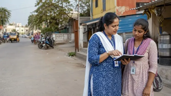 A field officer guiding a new colleague outdoors