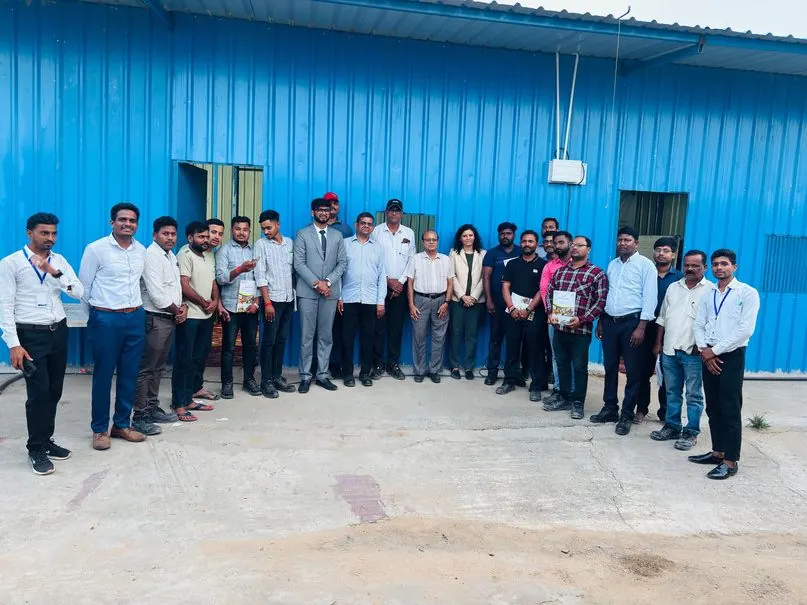 Participants and facilitators gathered outside a factory shed