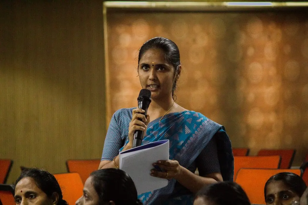 A participant speaking with a microphone